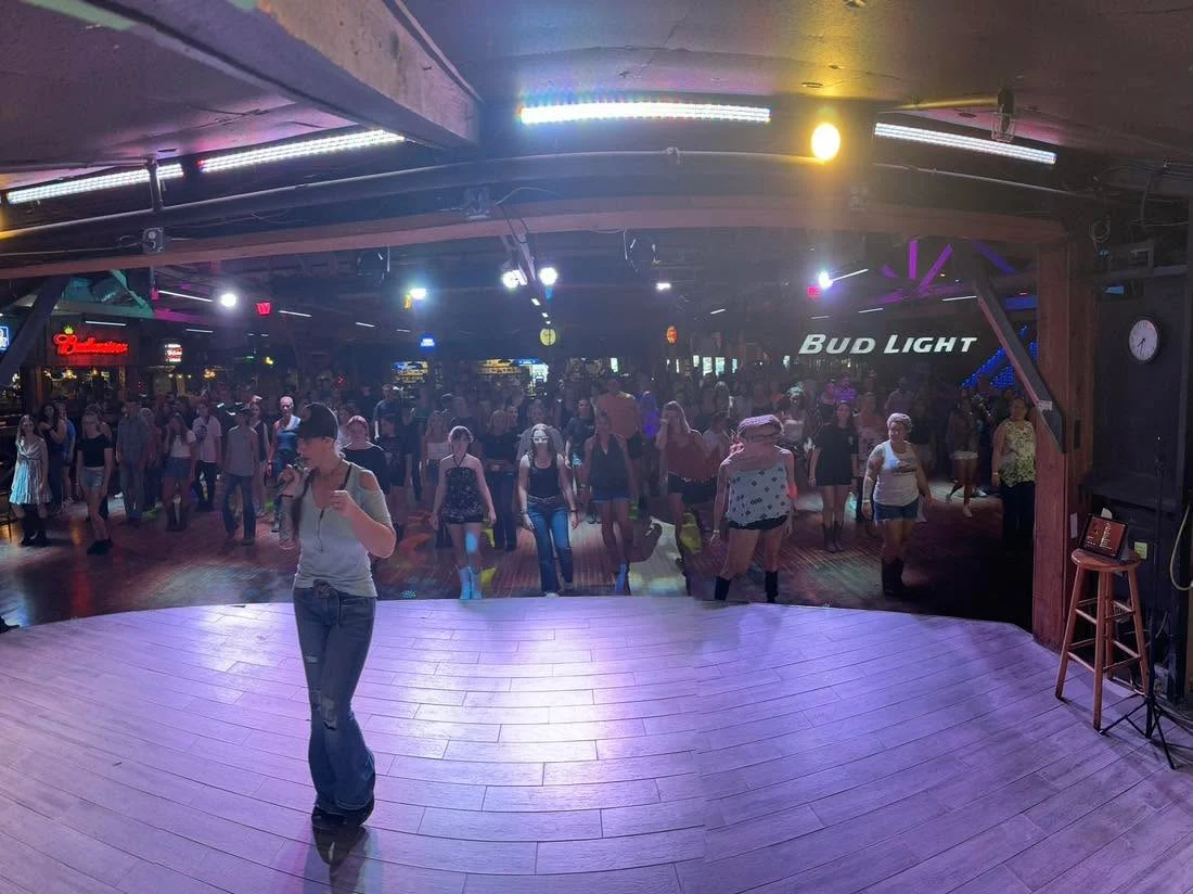 An instructor leading dancers at The Barn