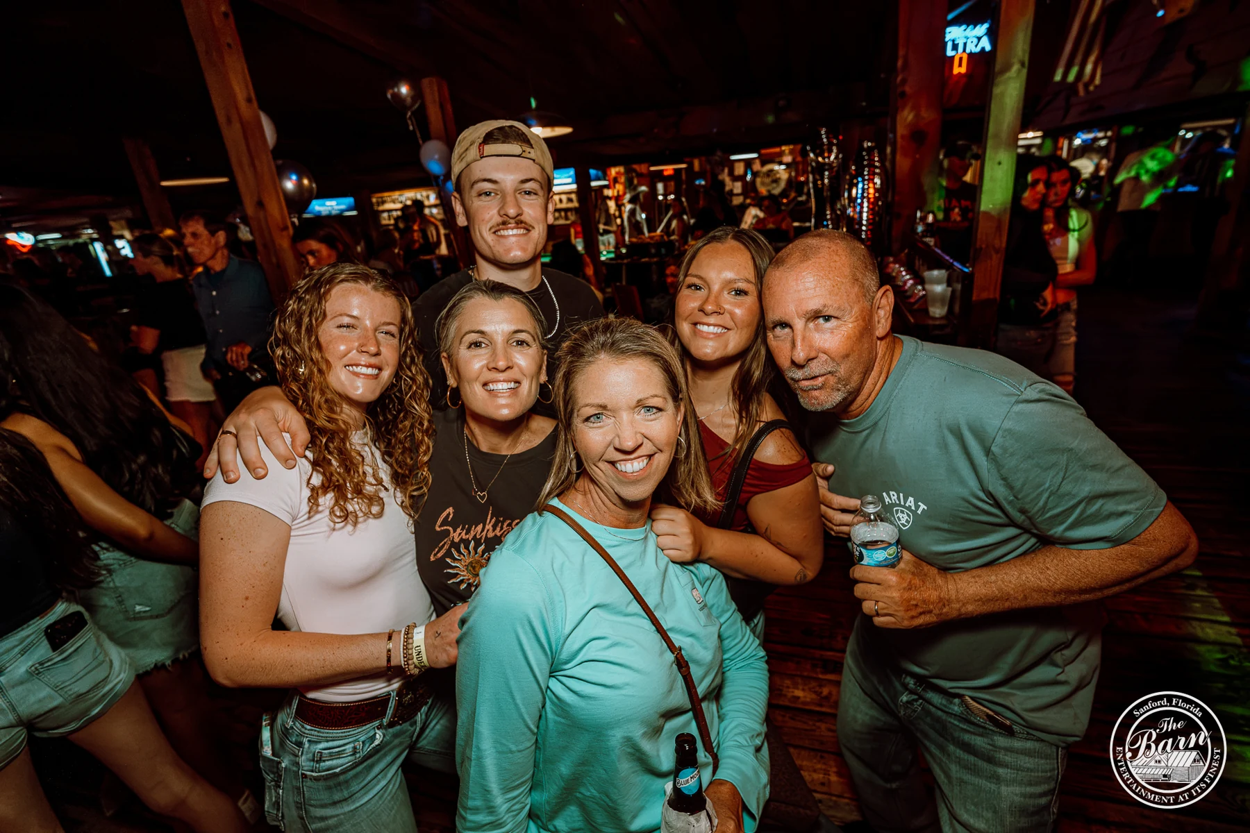 A guest group smiling together at The Barn