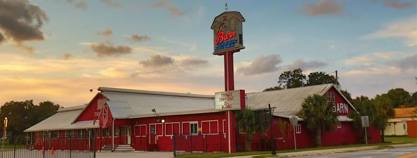 The Barn building and roadside sign at sunset