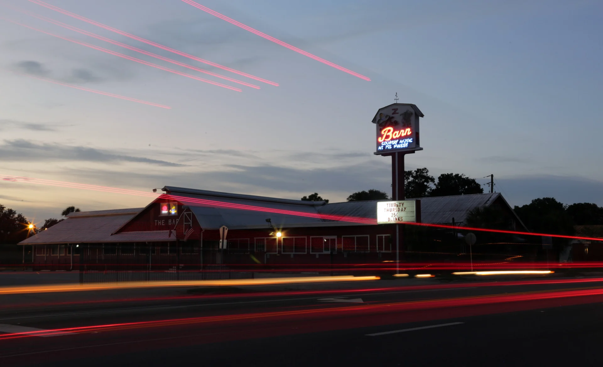 The red Barn building and roadside sign in Sanford
