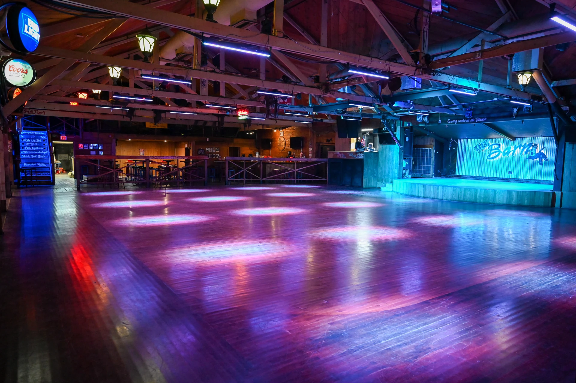 The Barn dance floor illuminated for an evening event